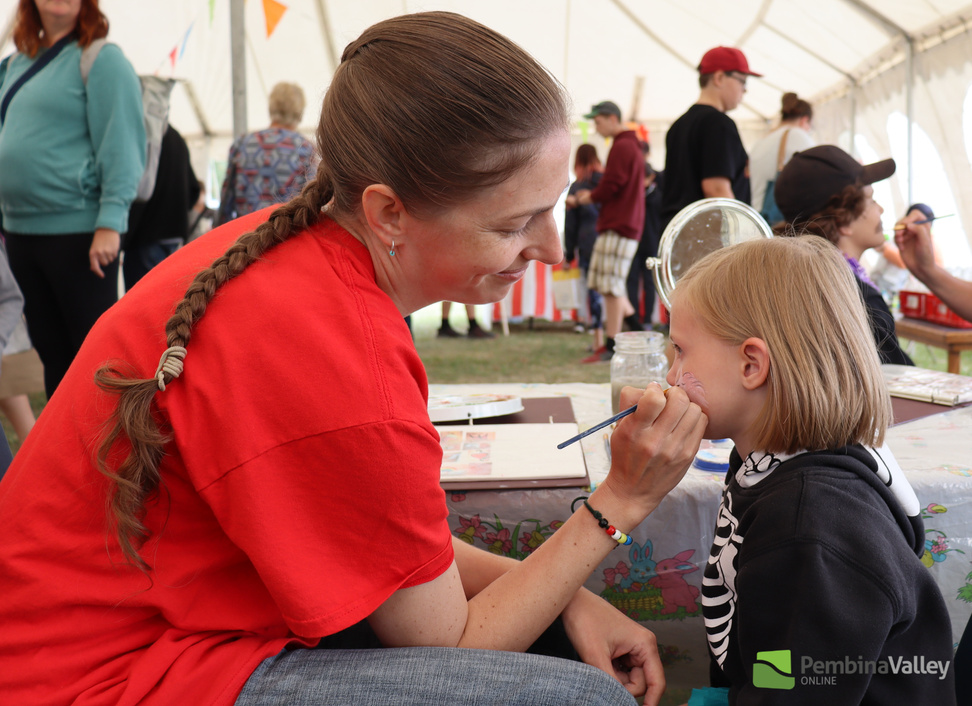 Face painting in the kids tent.